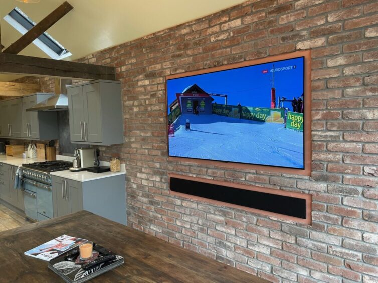 Wall decorated with brick slips cut from real bricks with tv and sound bar attached to the wall.