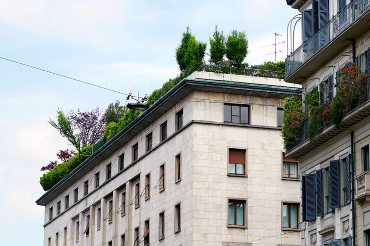 White building in Milan Italy with green roof including large plants and trees