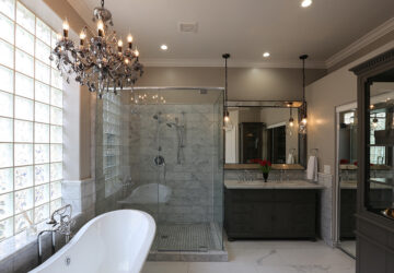 Luxury bathroom with roll top bath, walk in shower and chandelier