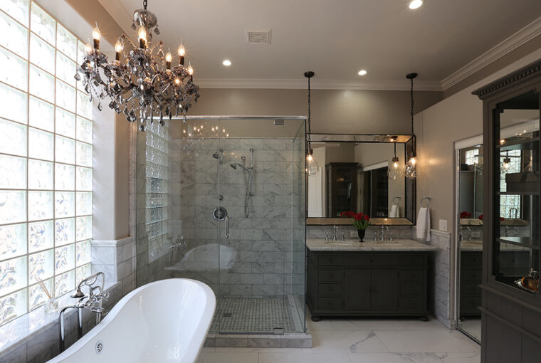 Luxury bathroom with roll top bath, walk in shower and chandelier