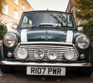 Car parked by the side of the road on a street with houses in London - Mini Mark VII