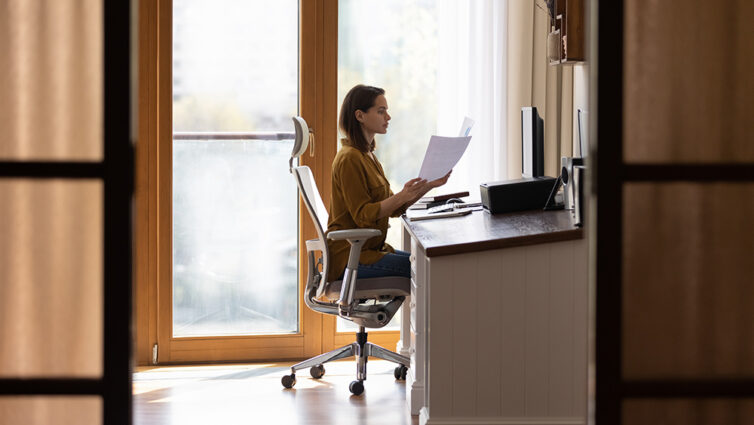 Women working from home in home office. Sat on ergonomic chair