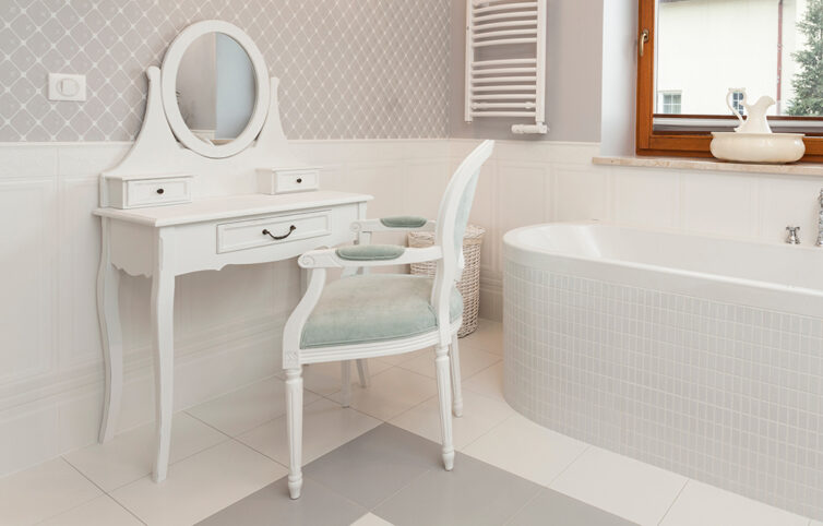 White tiled bathroom with dressing table and chair