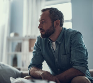 Man sat down looking worried