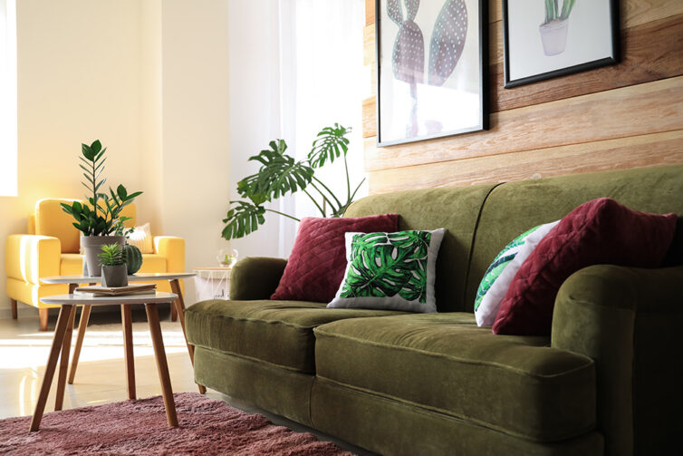 Green sofa with yellow armchair in the background