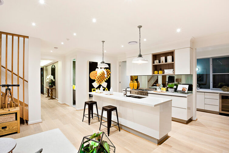 Modern white kitchen unites with large island and breakfast bar.