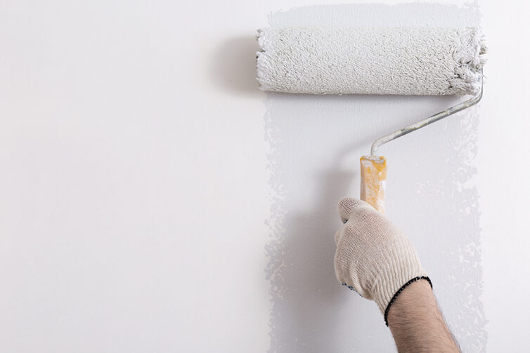 Painting white wall with a roller