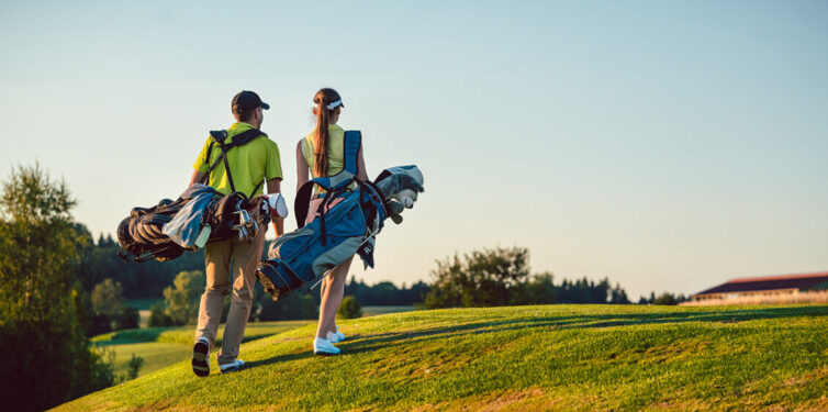 Man and women on walking on golf course