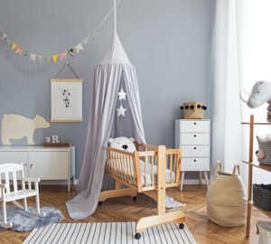 Scandinavian grey and white babies bedroom with small swinging cot