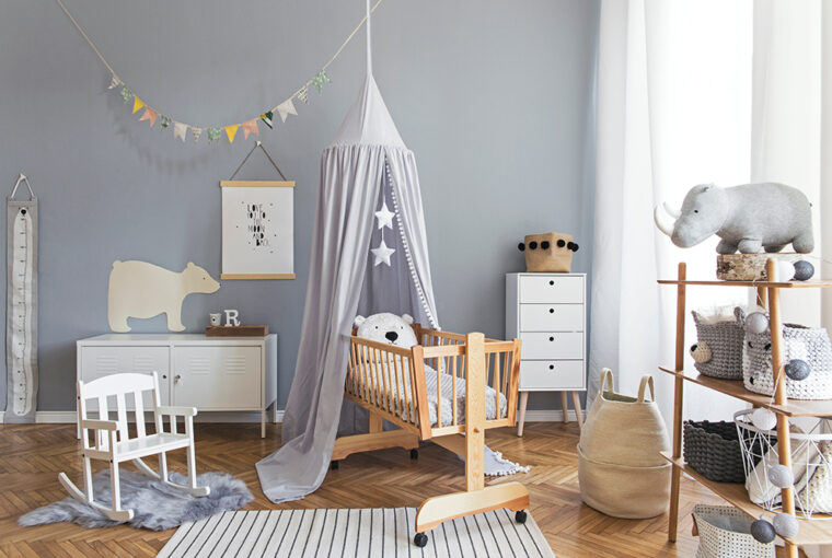 Scandinavian grey and white babies bedroom with small swinging cot