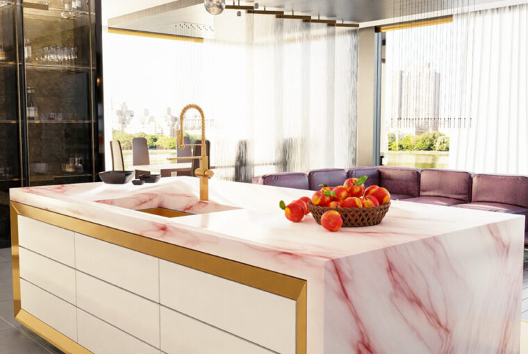 Modern designer kitchen with pink marble island counter top, with metal/brass draw triming and brass taps