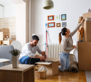 Man and women packing boxes for house move