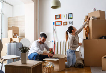 Man and women packing boxes for house move