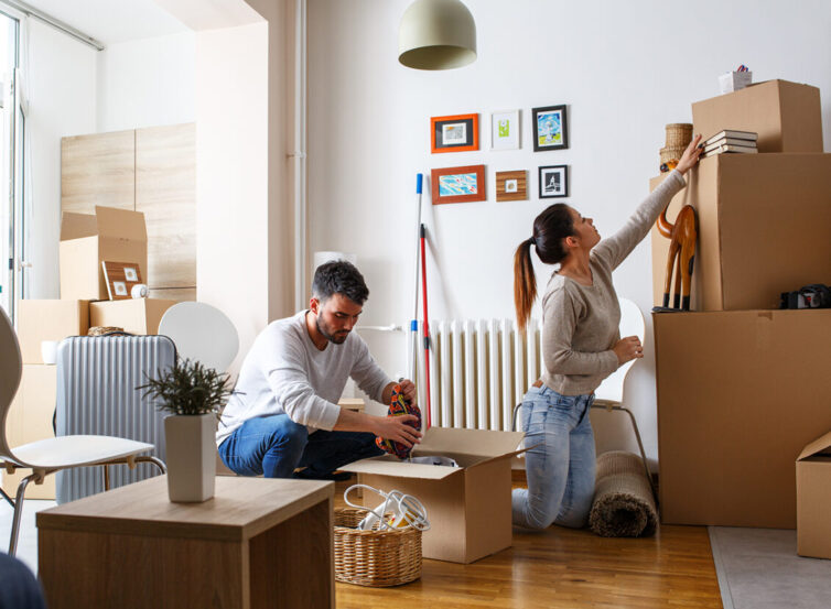 Man and women packing boxes for house move