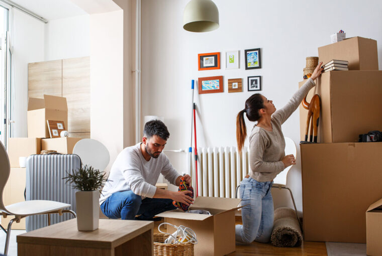 Man and women packing boxes for house move