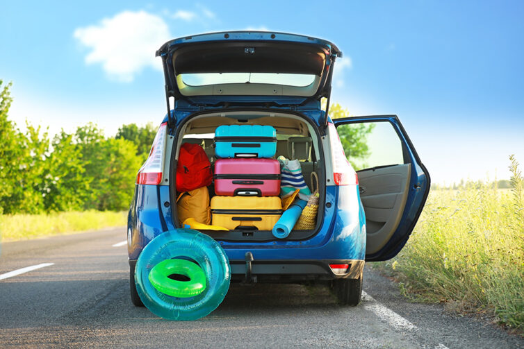 Blue car with boot fullof luggage for road trip