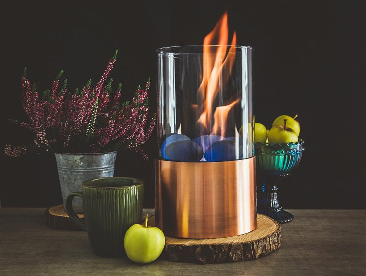 Stylish bioethanol fueled portable fireplace burning at home