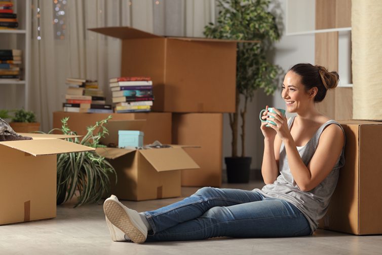 Happy tenant resting drinking coffee moving home