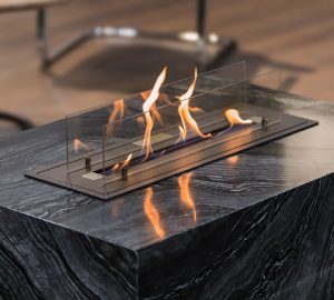 Beautiful marble black floor fireplace. Minimalism interior, alternative bio fireplot fireplace on ethanol gas