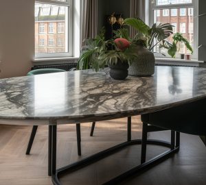 big curved oval marble table in a Amsterdam loft