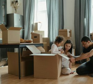 Family sat in a room with boxes