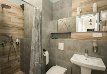 Bathroom With Grey Tiles And Faux Wood PVC Wall Panels